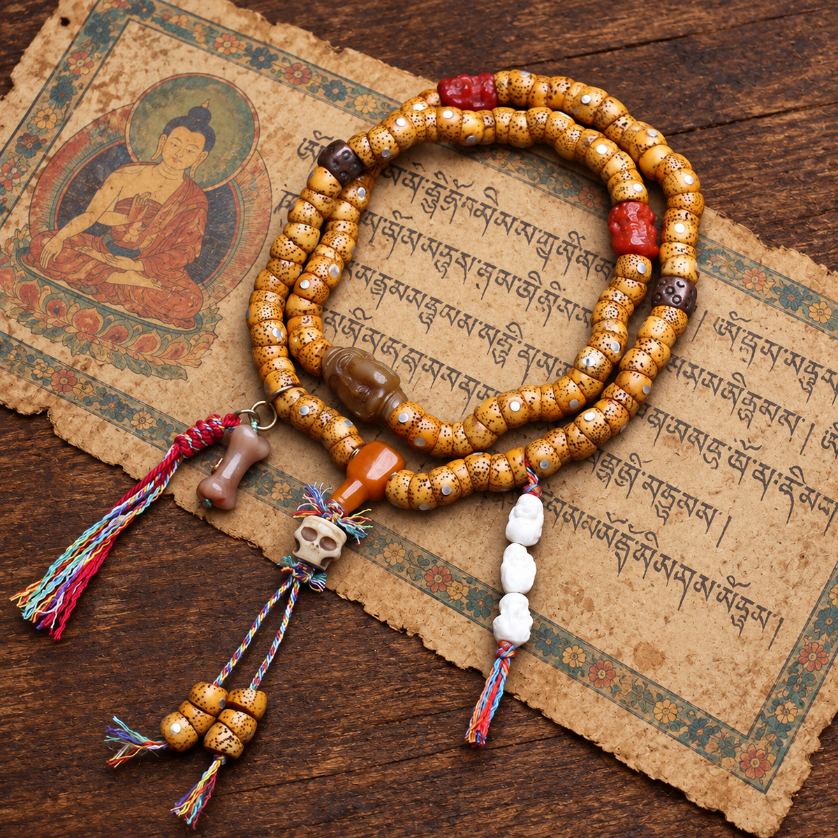 EverestArtstudios Xingyue Bodhi 108-Bead Mala with Yak Bone and Red Agate Accents — styled on wood with a scripture display prop